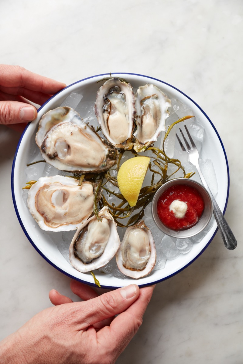 Fresh oysters on ice with cocktail sauce