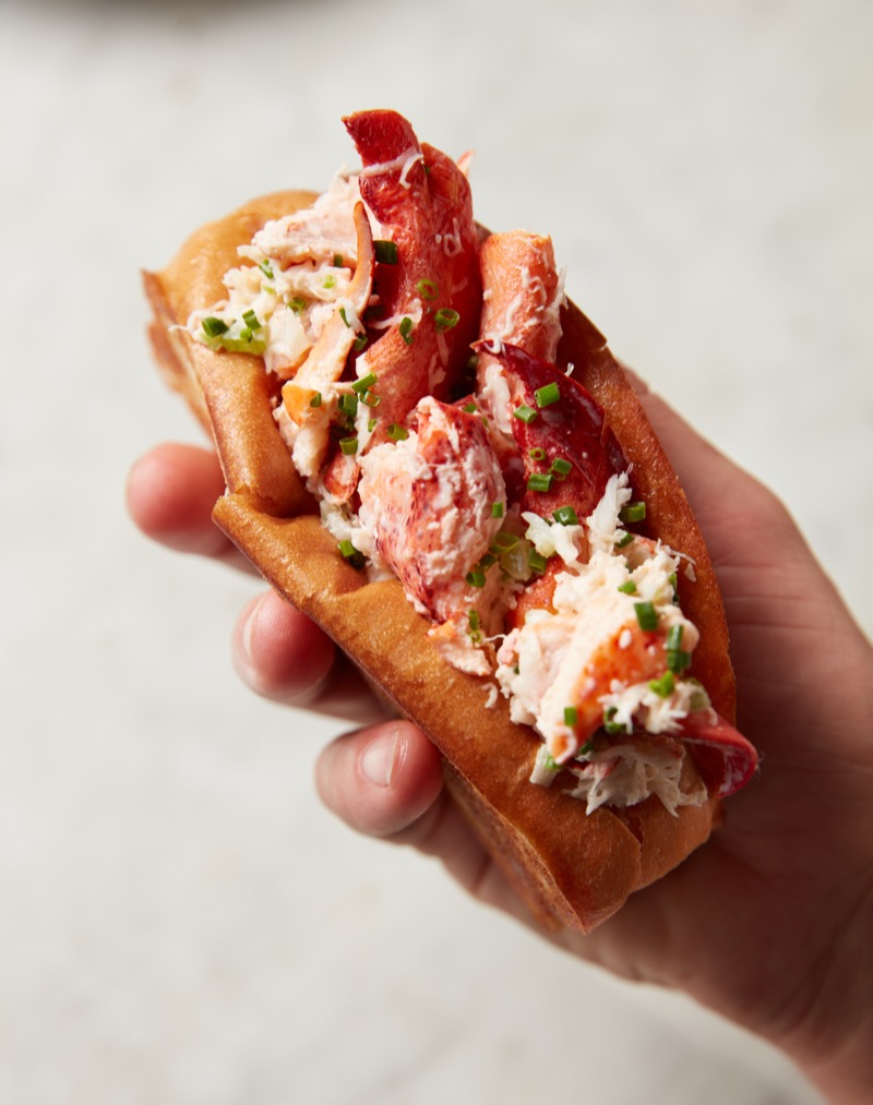 Close-up of lobster roll held in hand