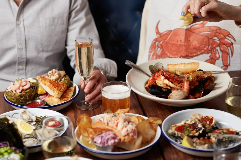 Table spread with champagne and seafood